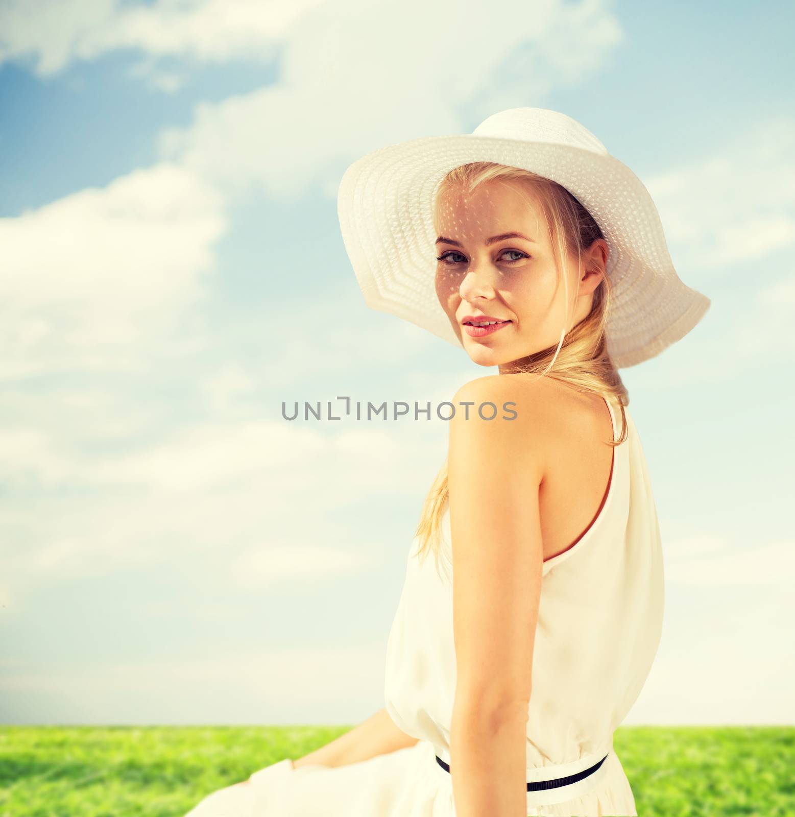 fashion and lifestyle concept - beautiful woman in hat enjoying summer outdoors