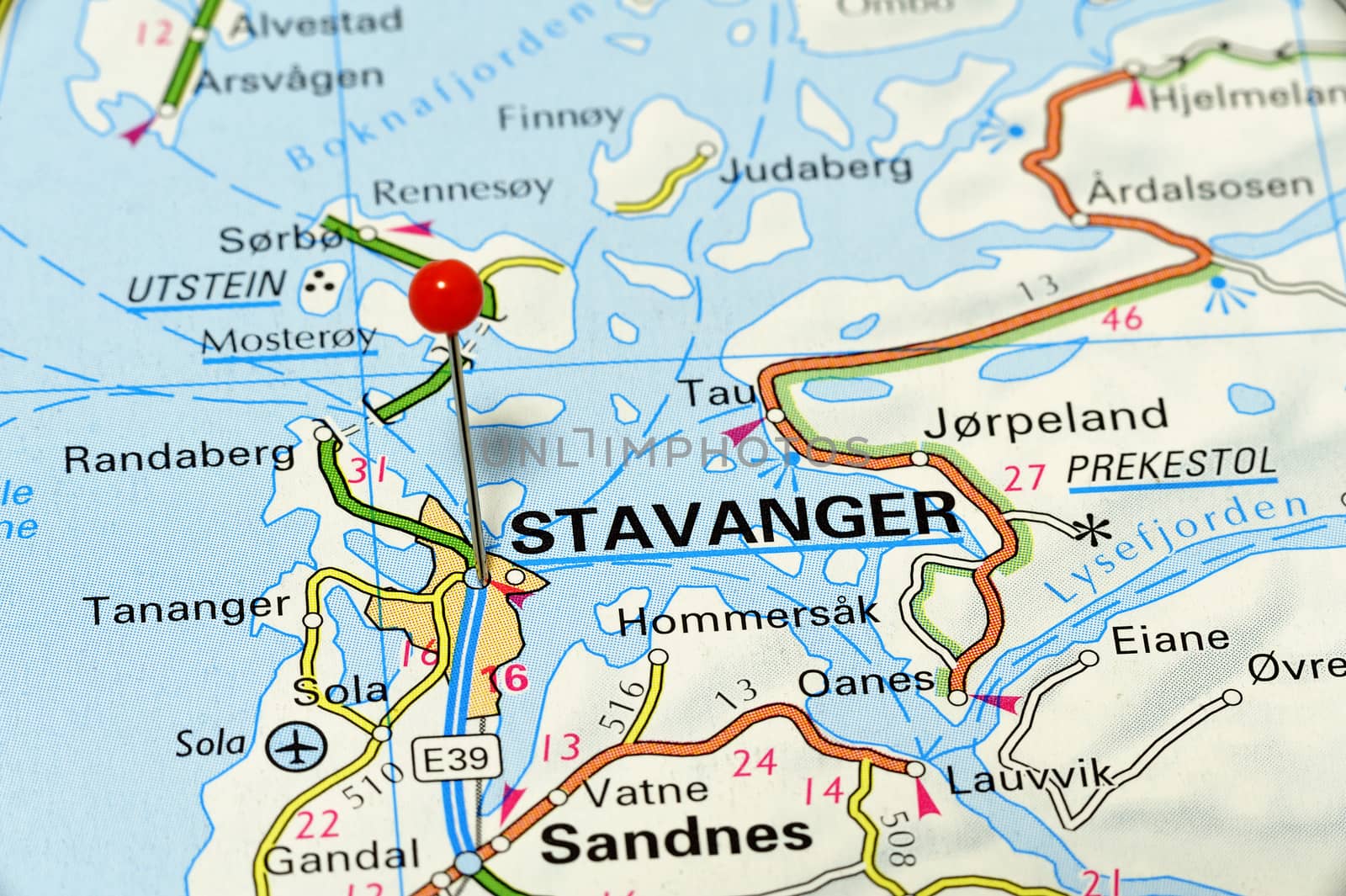 Stavanger - famous city in Norway. Red flag pin on an old map showing travel destination.