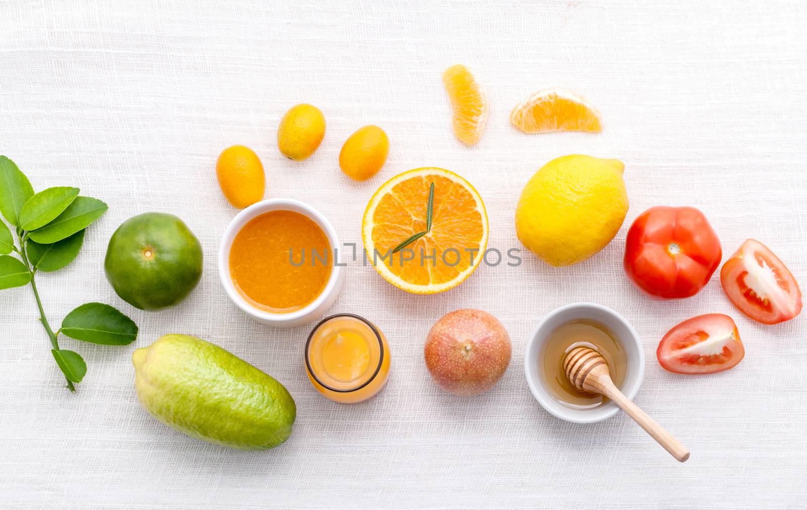 Breakfast with orange juice, oranges, oranges slice, passion fruit , ginger,tomato and Kiwi set up on wooden table .