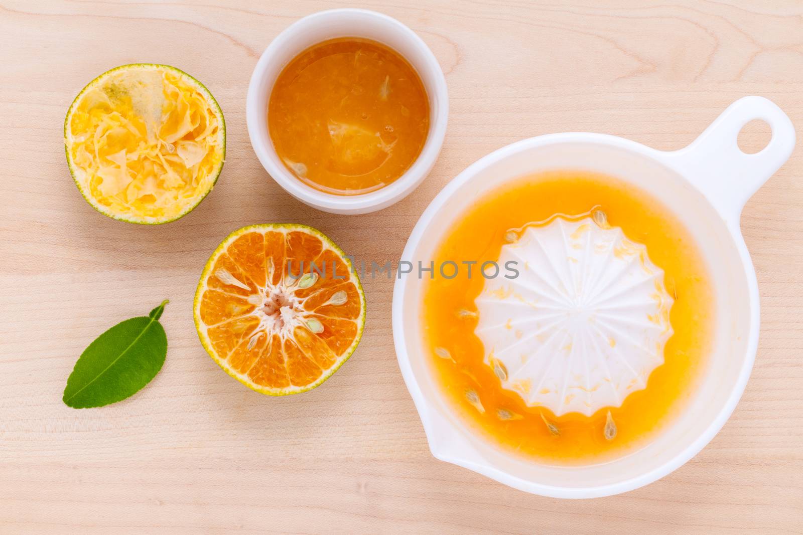 Freshly orange juice with orange slice set up on wooden table .