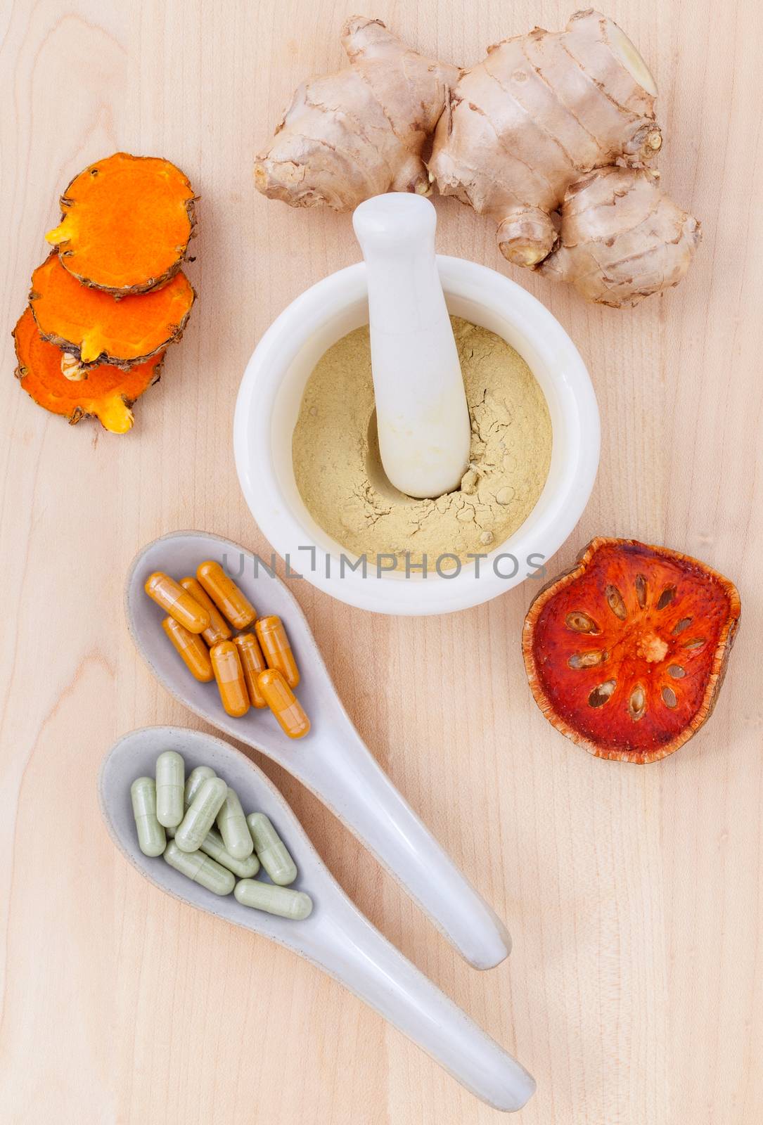 Alternative health care fresh herbal  ,dry and herbal capsule with mortar on wooden background.