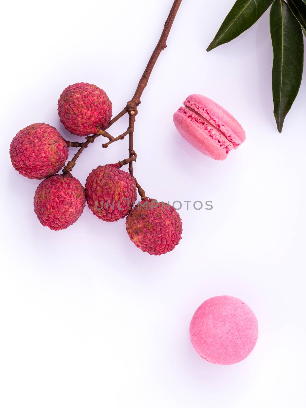 Brunch of ripe lychee and lychee macaroons with leaf isolate on  by kerdkanno