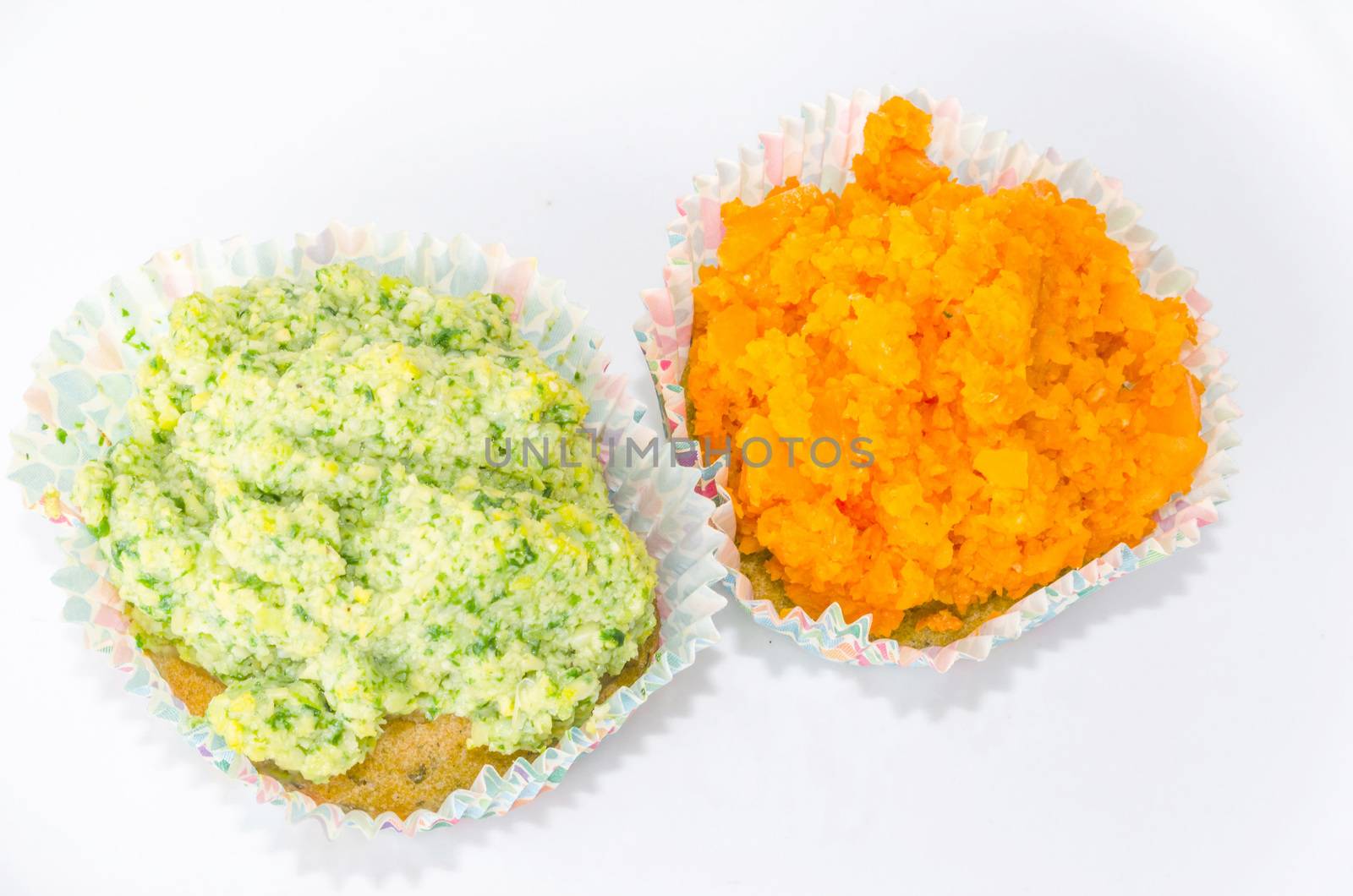 Two muffins with fresh fruit and vanilla pod on a light background