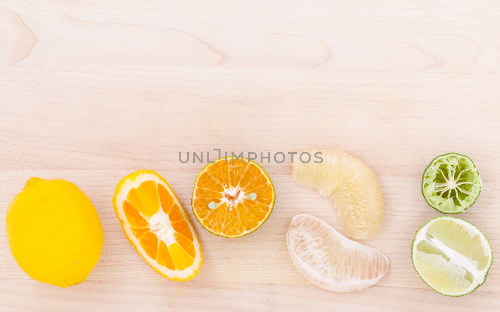 Mixed citruses fruit oranges, pomelo , lemon and lime on wooden  by kerdkanno