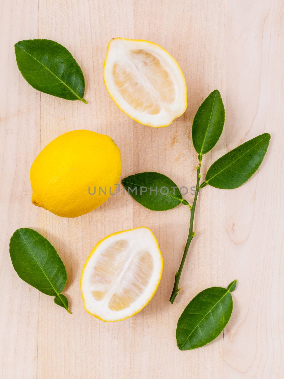 Fresh lemons and o lemons  slice on wooden background with  lemons  leaf.