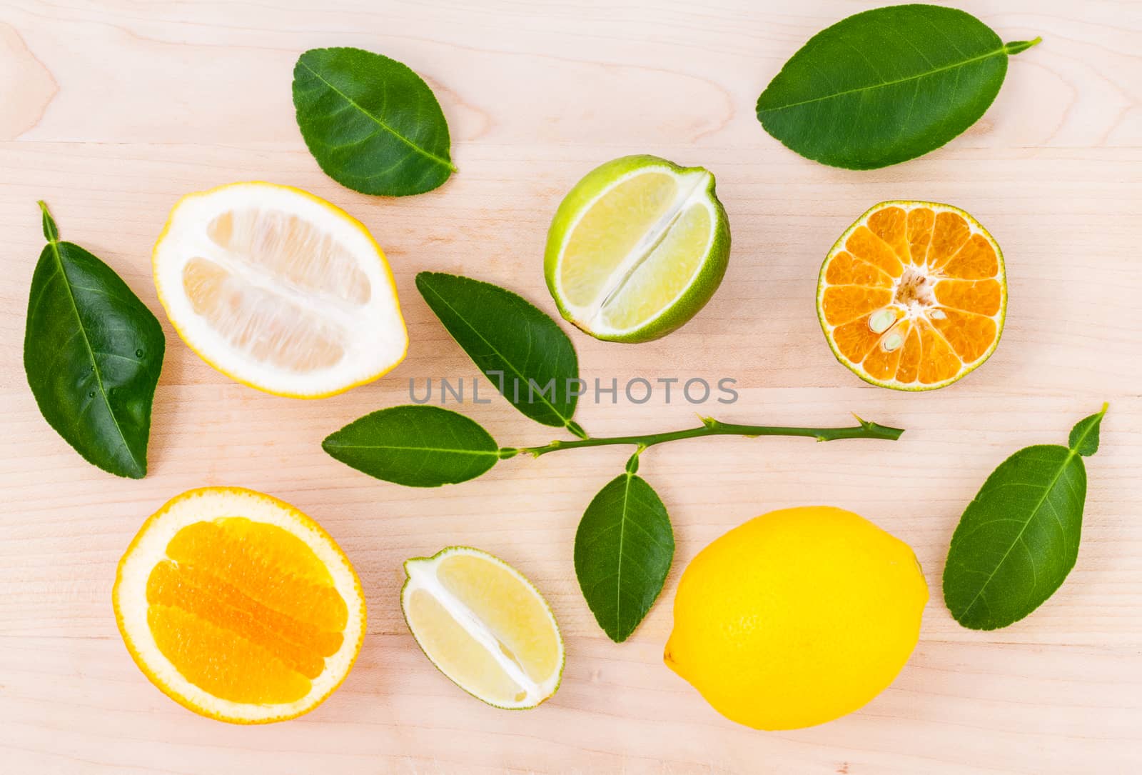 Mixed citruses fruit oranges, lemon and lime on wooden backgroun by kerdkanno