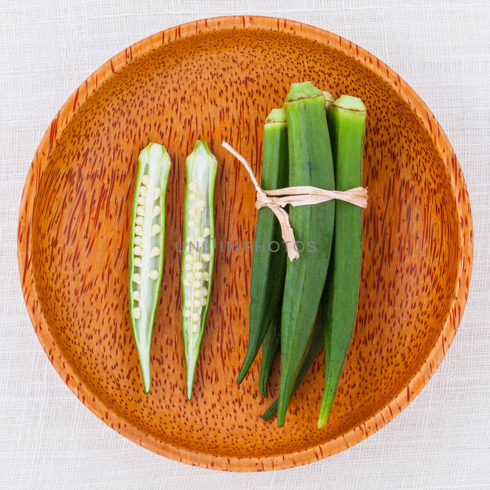 Lady 's Fingers or Okra clean and healthy food on white table . by kerdkanno