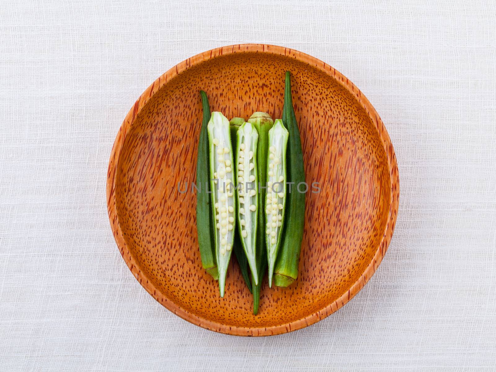 Lady 's Fingers or Okra clean and healthy food on white table . by kerdkanno