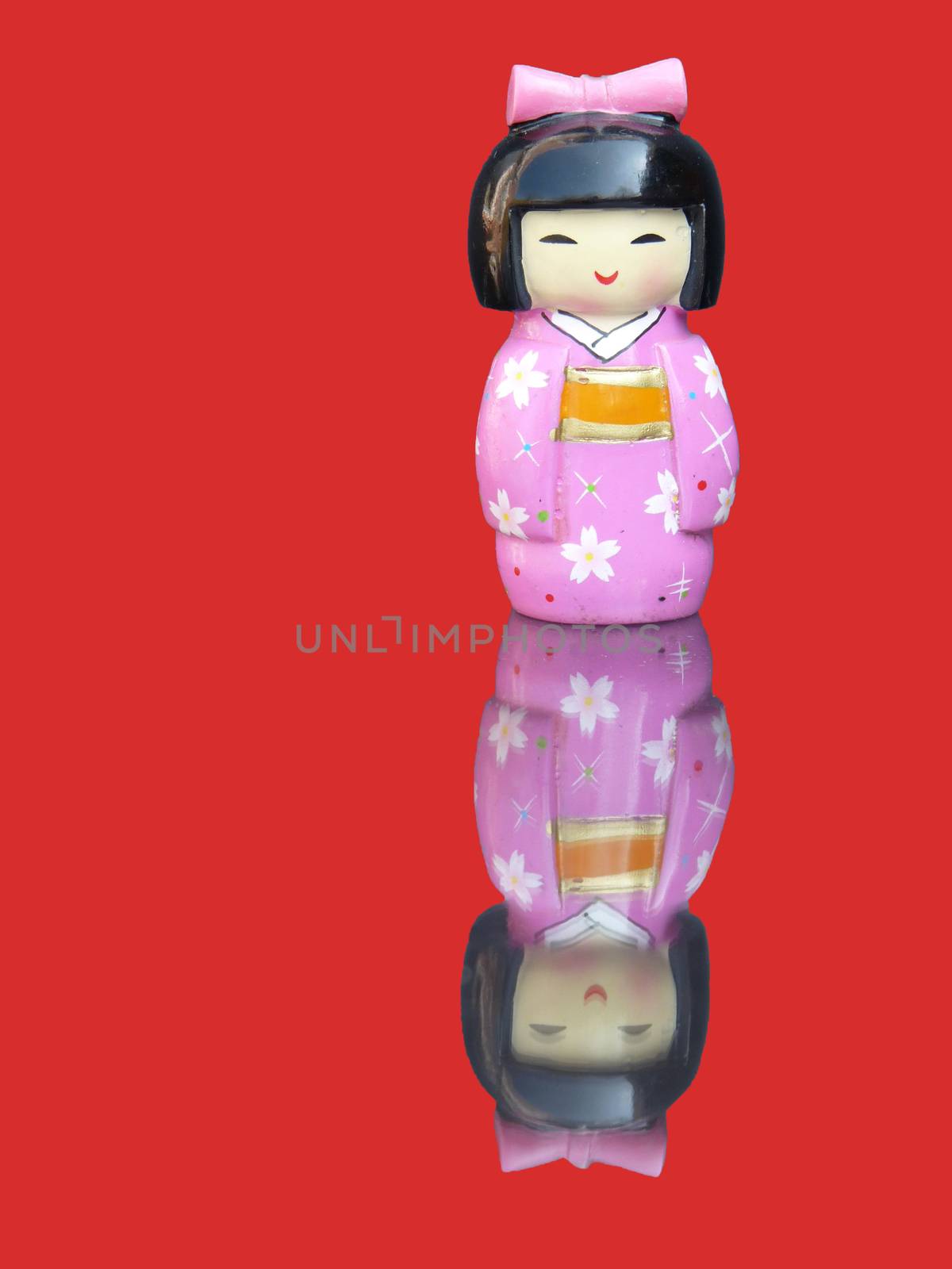 Porcelain chinese figurine with mirror image isolated on red background