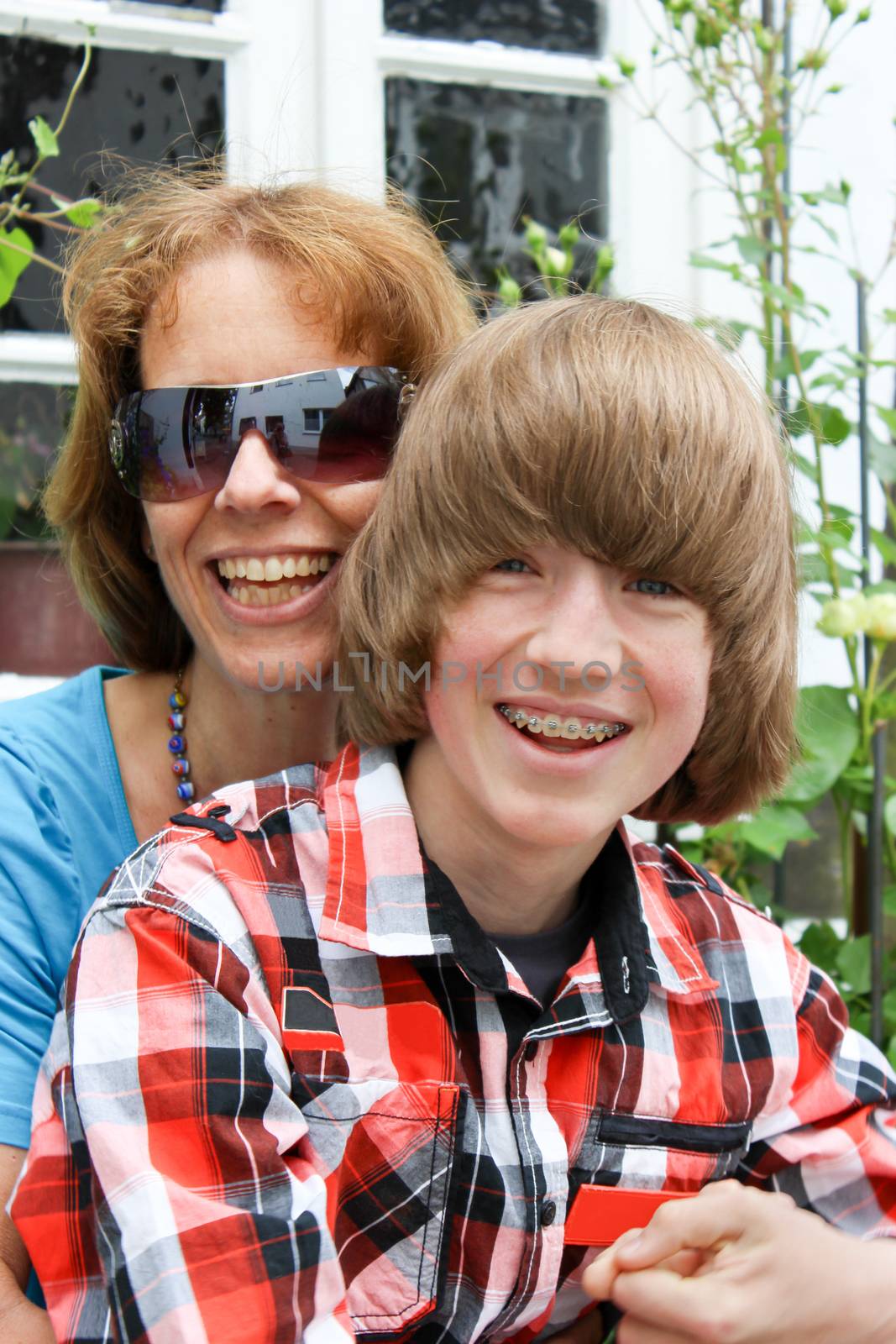 Mother with son on her lap both laughing