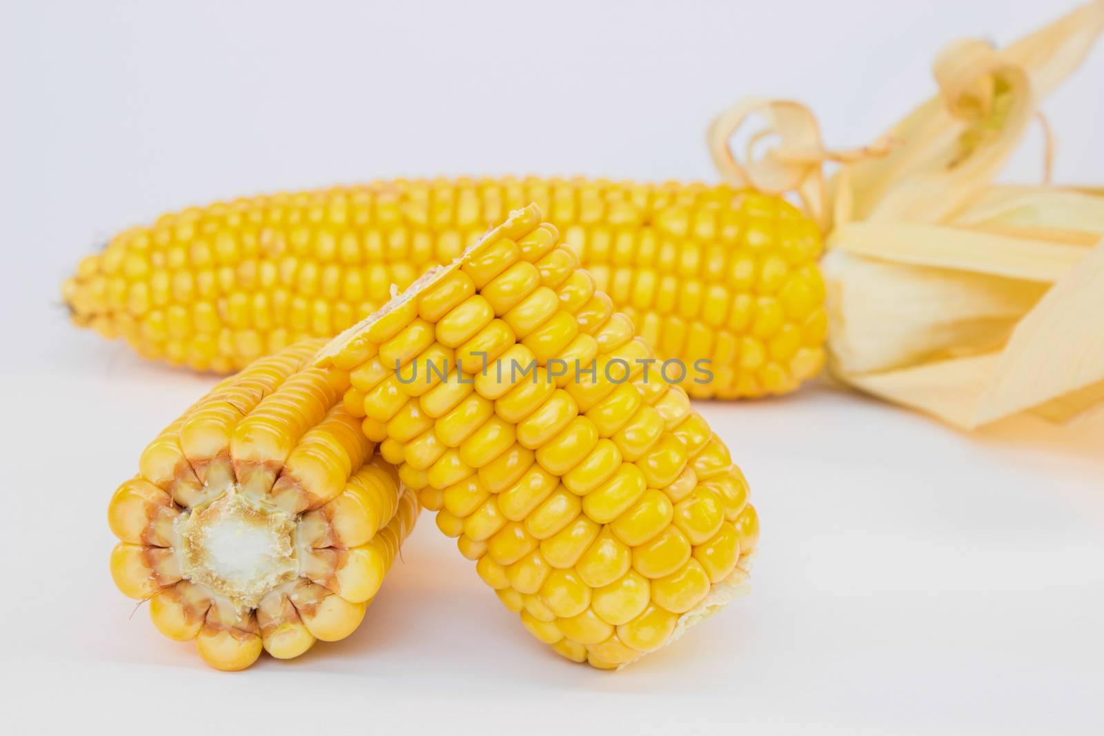 Whole and halve corncobs isolated on white background