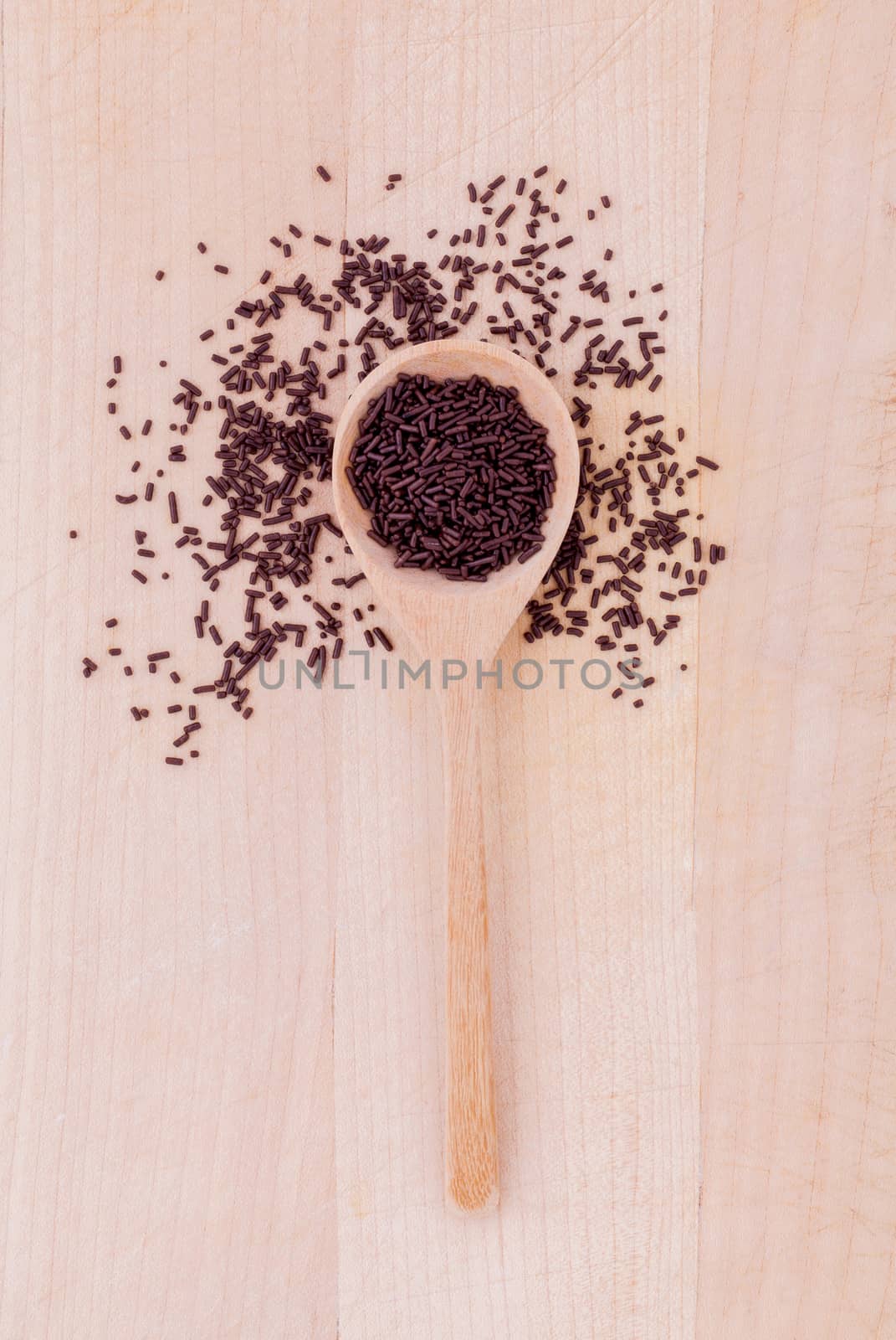 The chocolate topping  of baking in wooden spoon on wooden table .