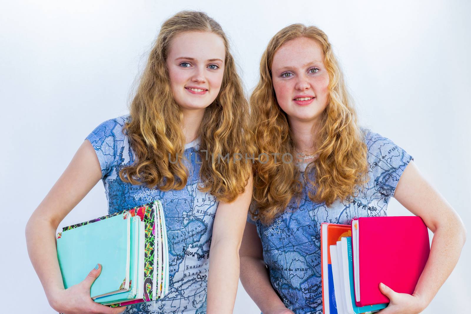 Schoolgirls carrying textbooks by BenSchonewille