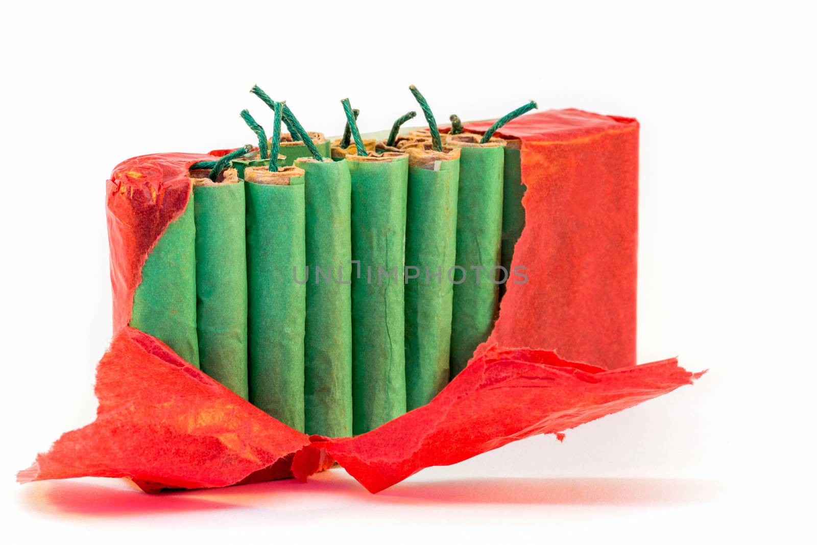 Standing green firecrackers in packet with red paper isolated on white background
