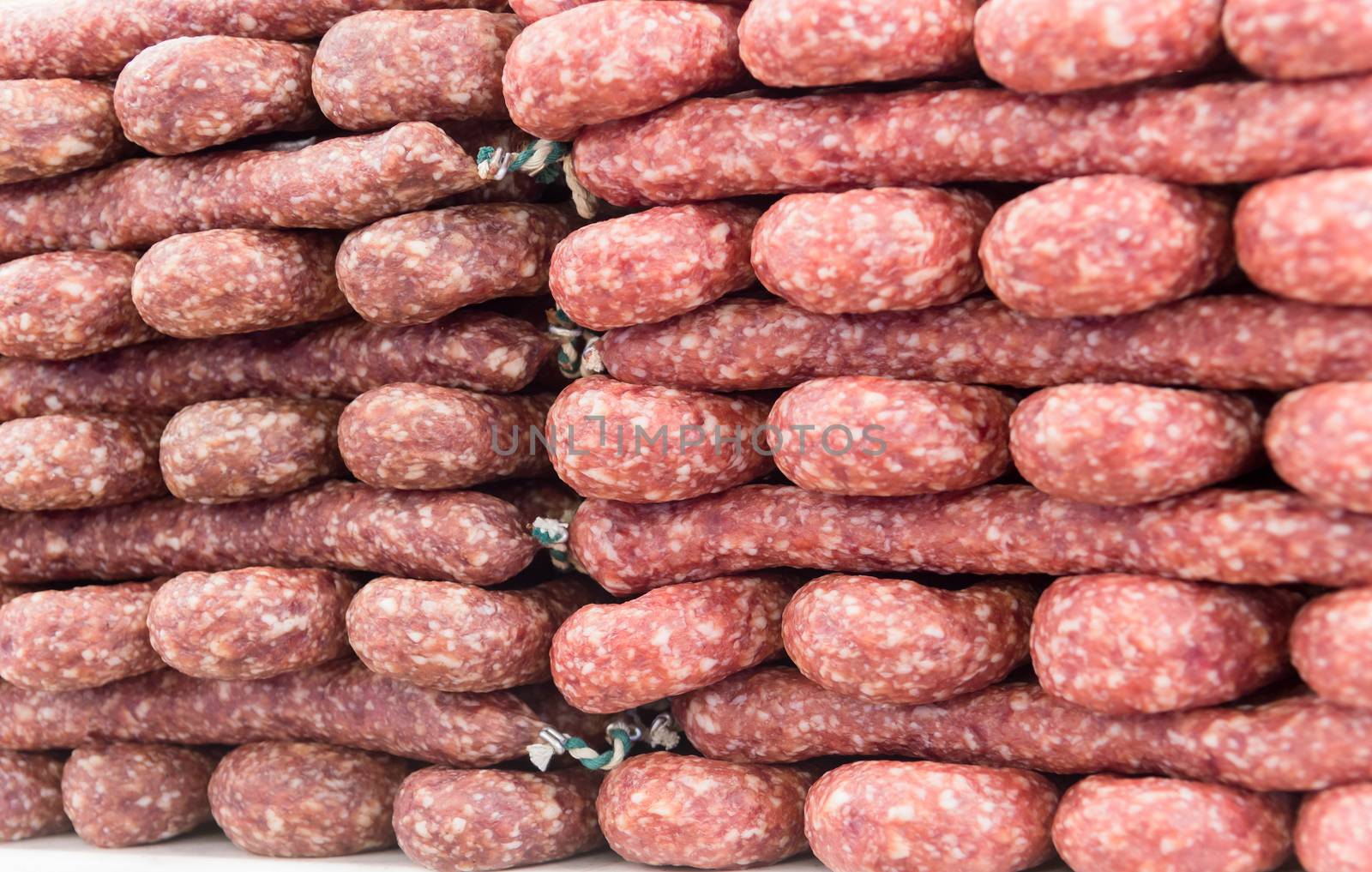 Many piled dried sausages as a construct at market