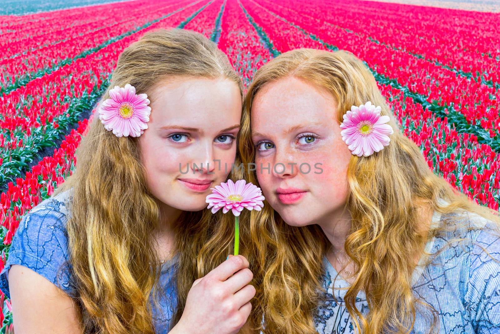 Two girls in front of red tulip field by BenSchonewille