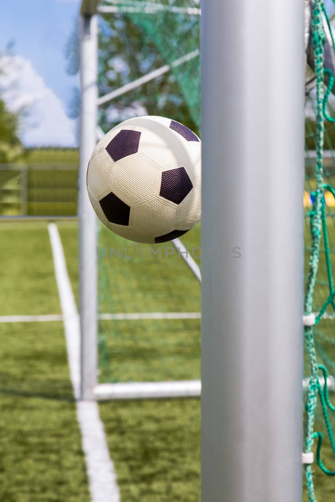 Football between goalposts by BenSchonewille