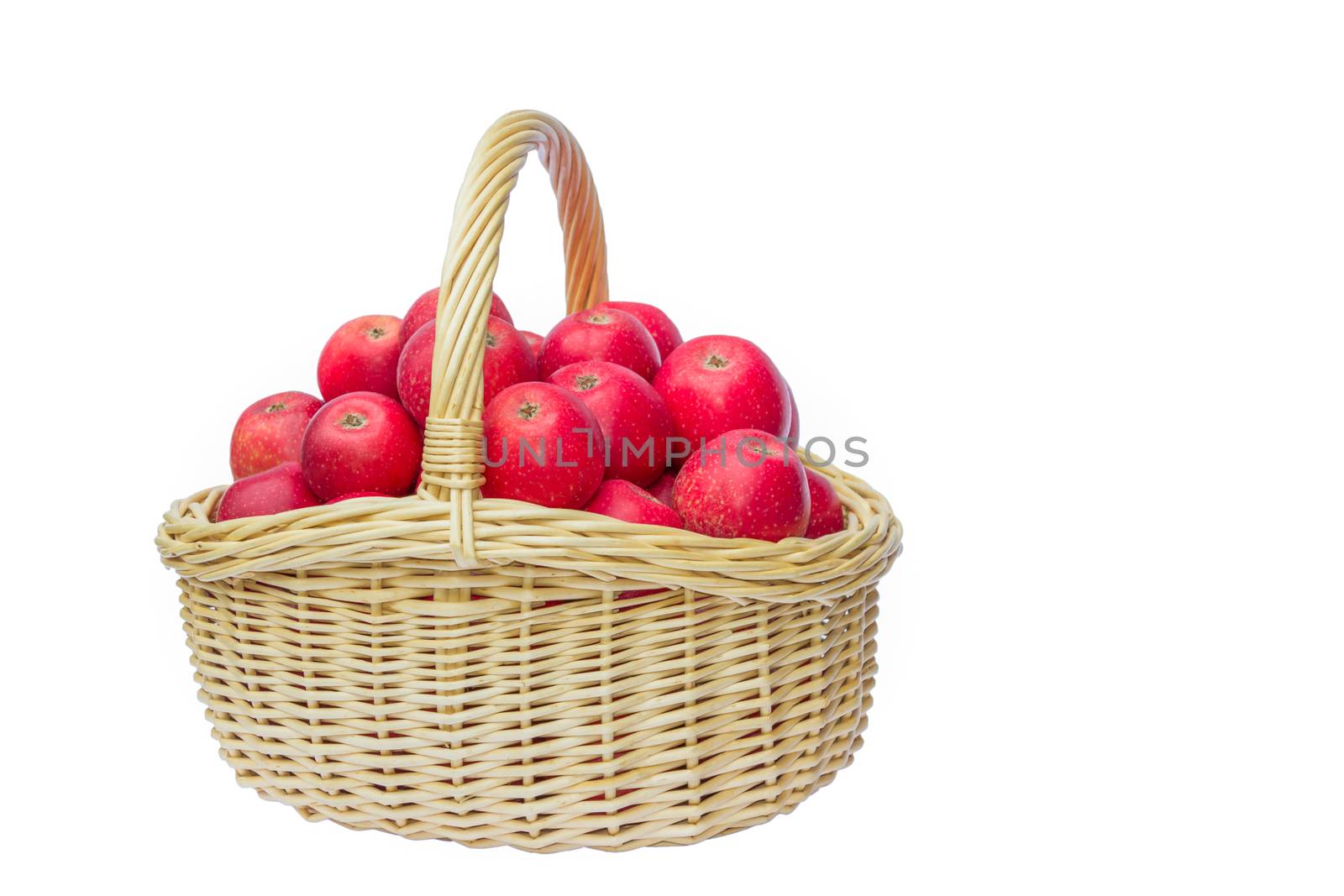 Full basket with many stacked red apples isolated on white background