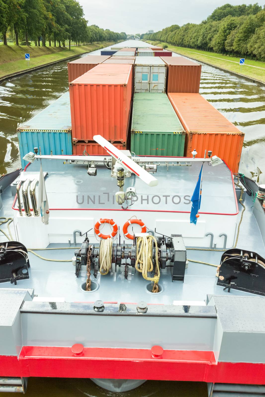 Ship carrying metal cargo containers on river