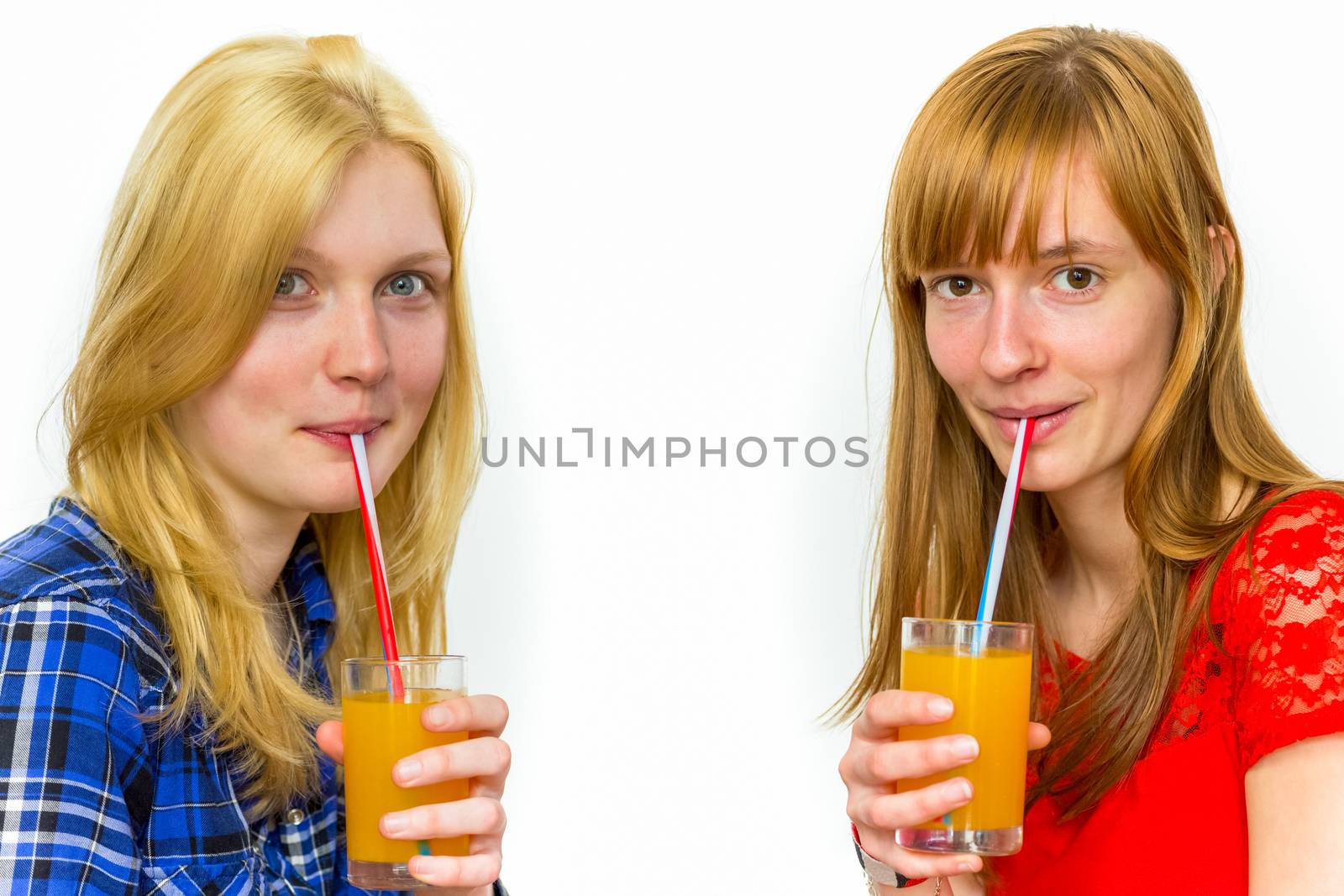 Two teenage girls drinking soft drinks by BenSchonewille