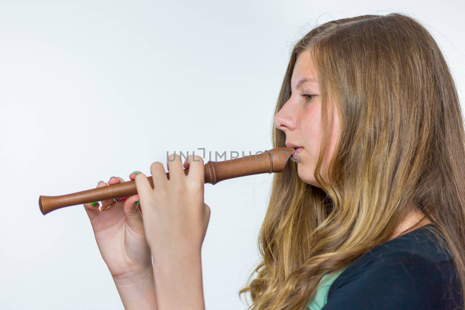 Blonde dutch teenage girl playing flute by BenSchonewille
