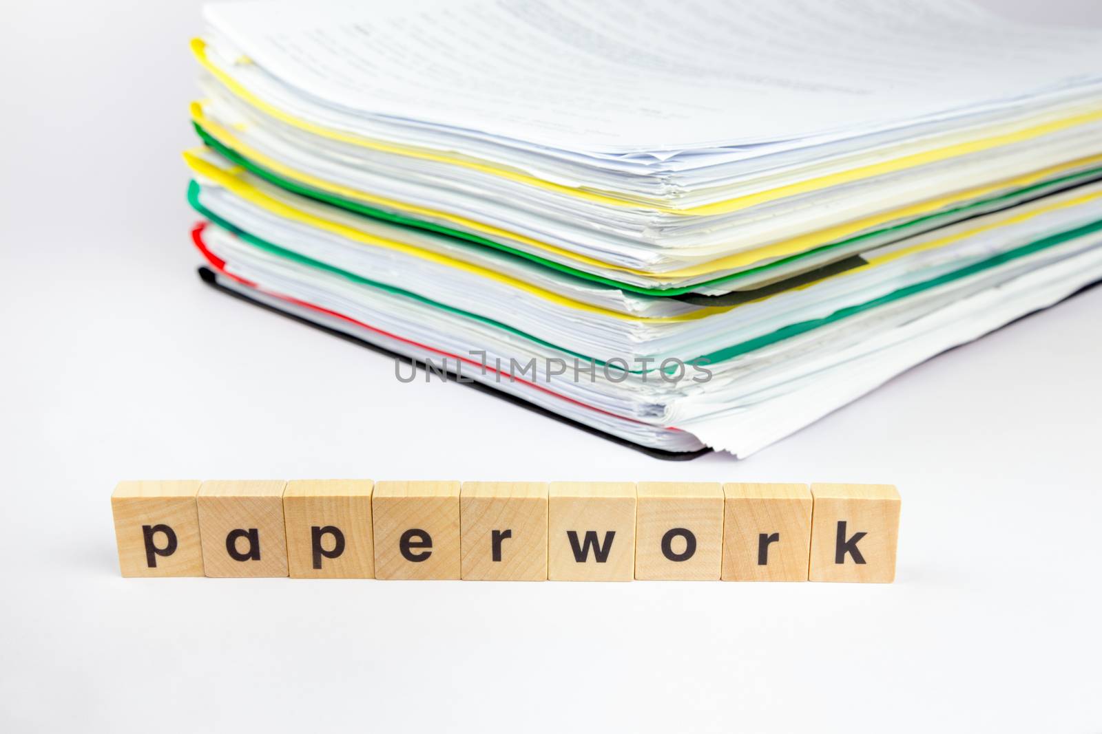 Stack of papers with word paperwork on wooden blocks