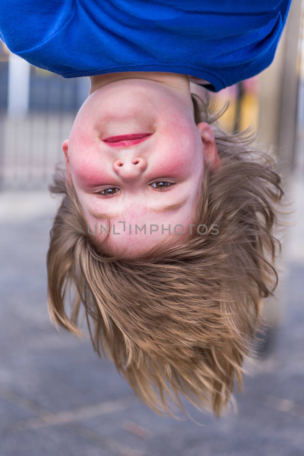 Young dutch girls head hanging upside down at playground