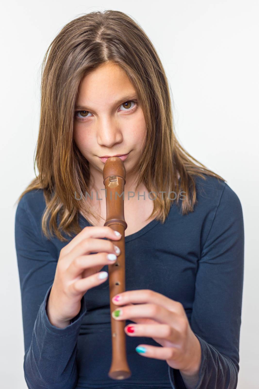 Caucasian teenage girl playing flute isolated on white background