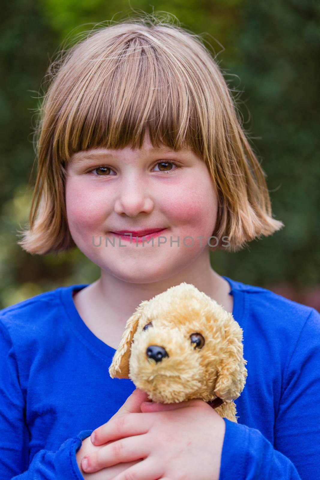 Young dutch girl holding hugging stuffed dog