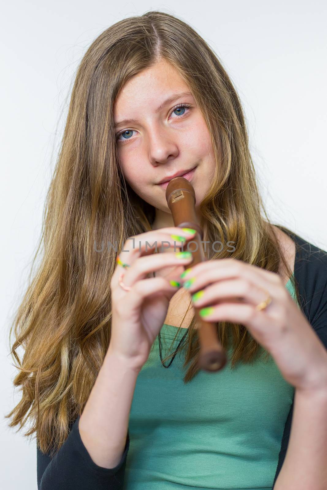 Blonde teenage girl playing the flute by BenSchonewille