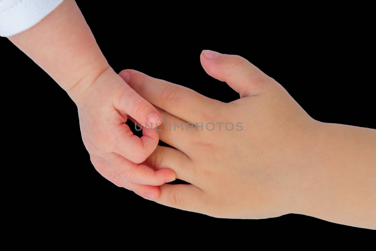 Hand of baby touching hand of child by BenSchonewille