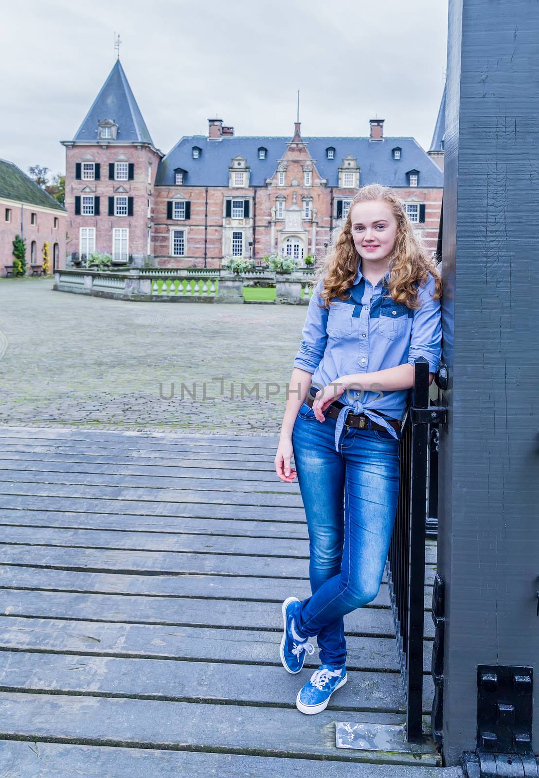 Blonde girl at entrance of castle by BenSchonewille