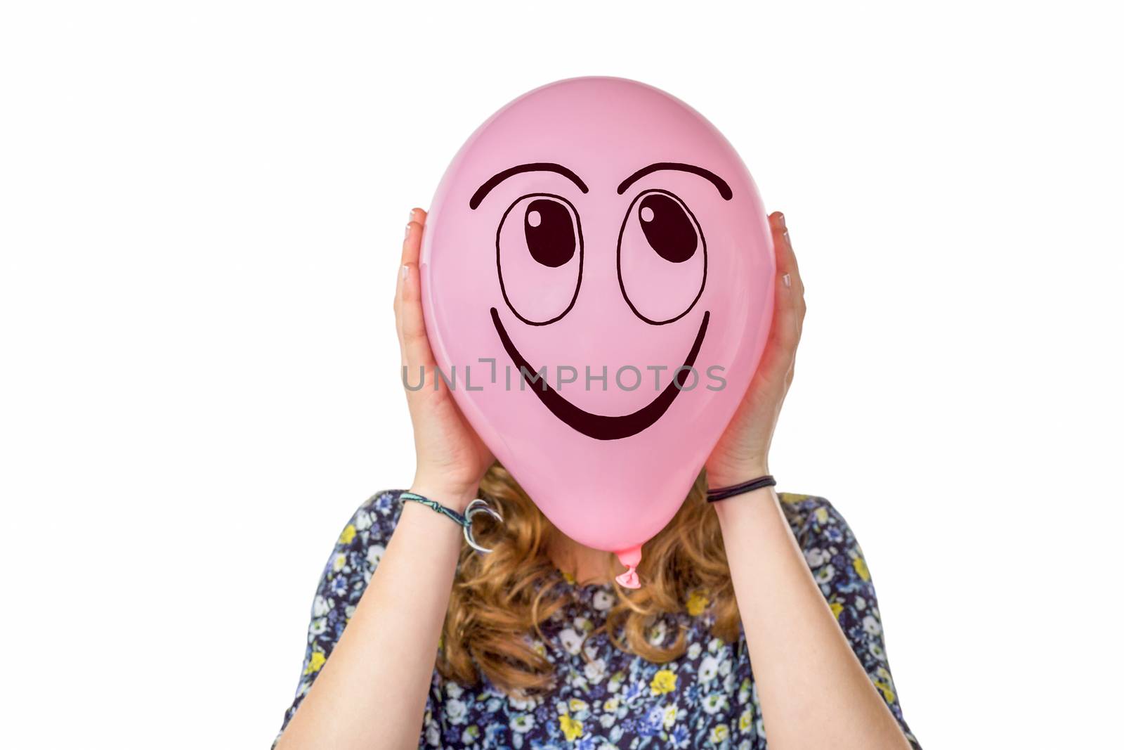 Girl holding pink balloon with smiling face by BenSchonewille