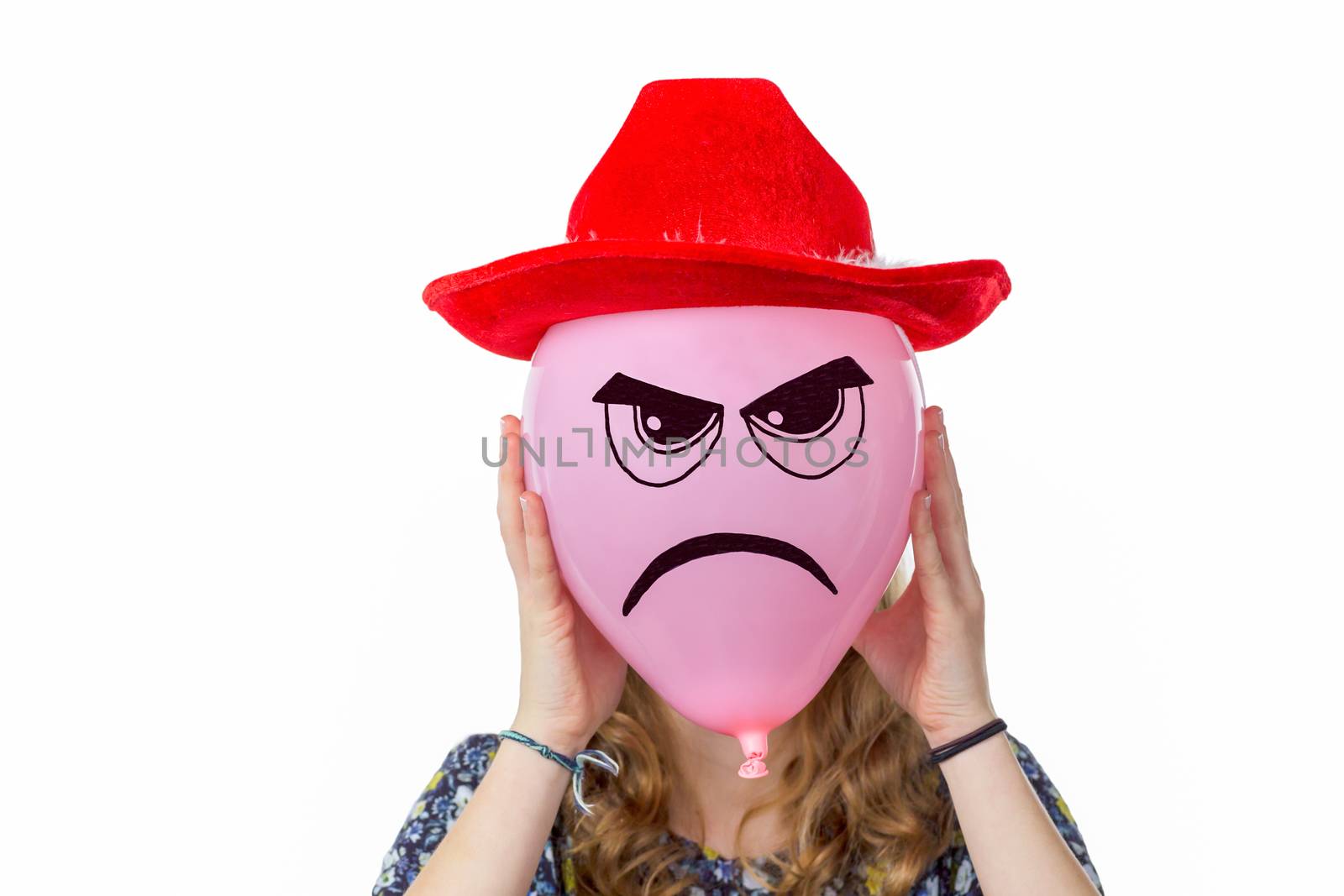 Girl holding pink balloon with angry face and red hat isolated on white background
