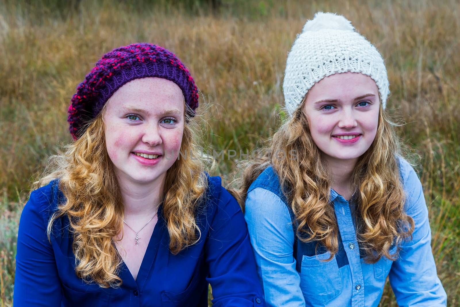 Two european teenage girls wearing hats in nature