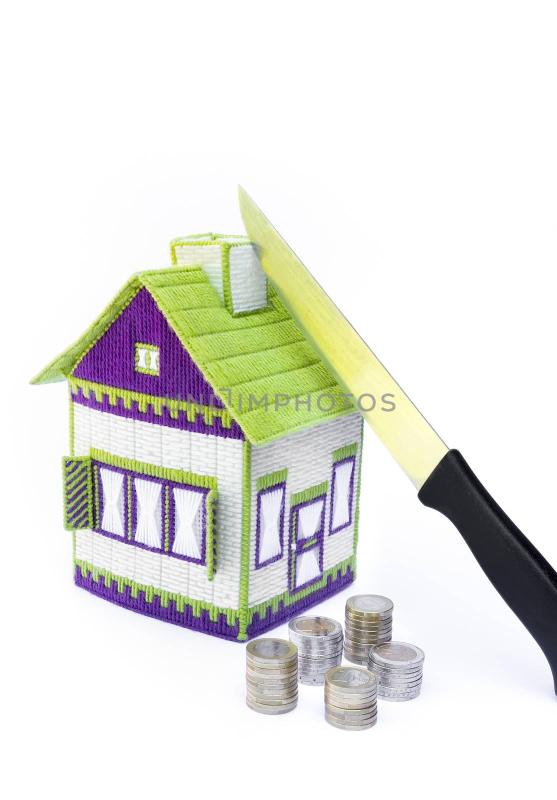 Knife cutting dividing house in two halves with euro money isolated on white background