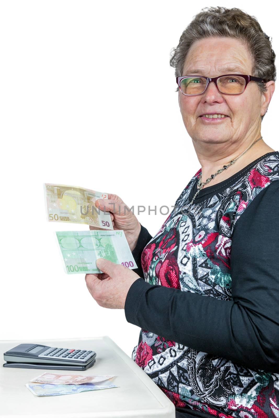 Senior caucasian  woman counting and showing money with calculator isolated on white background