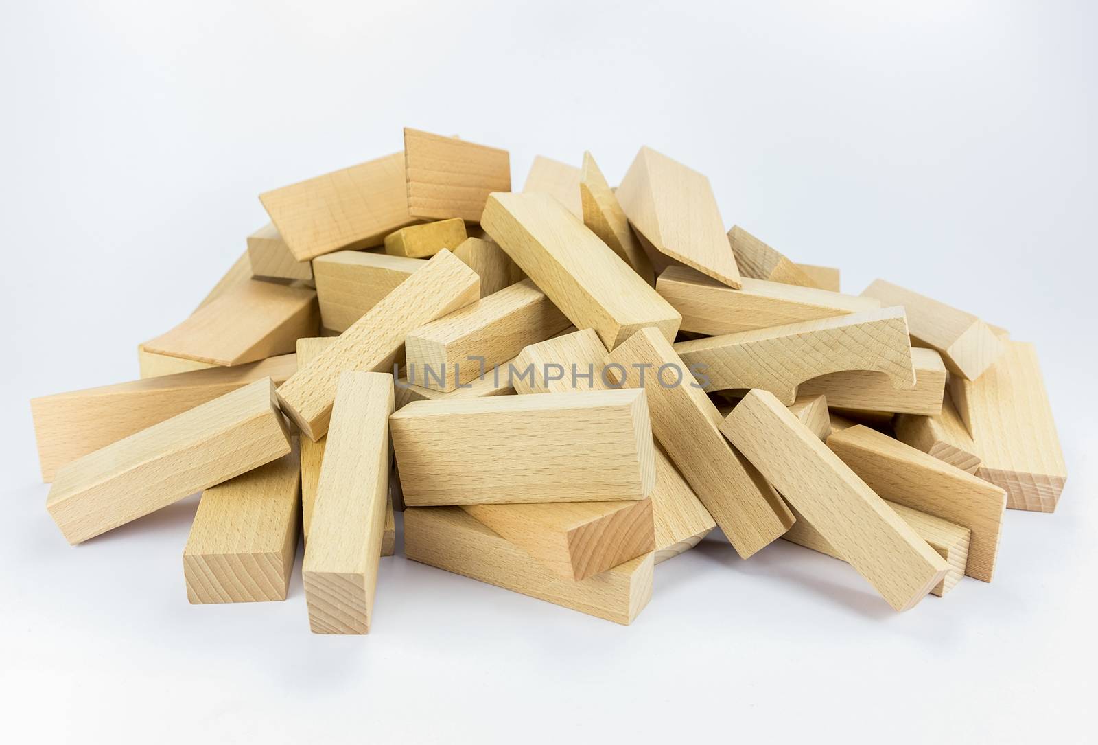Stack or pile of wooden building blocks to build construction, isolated on white background