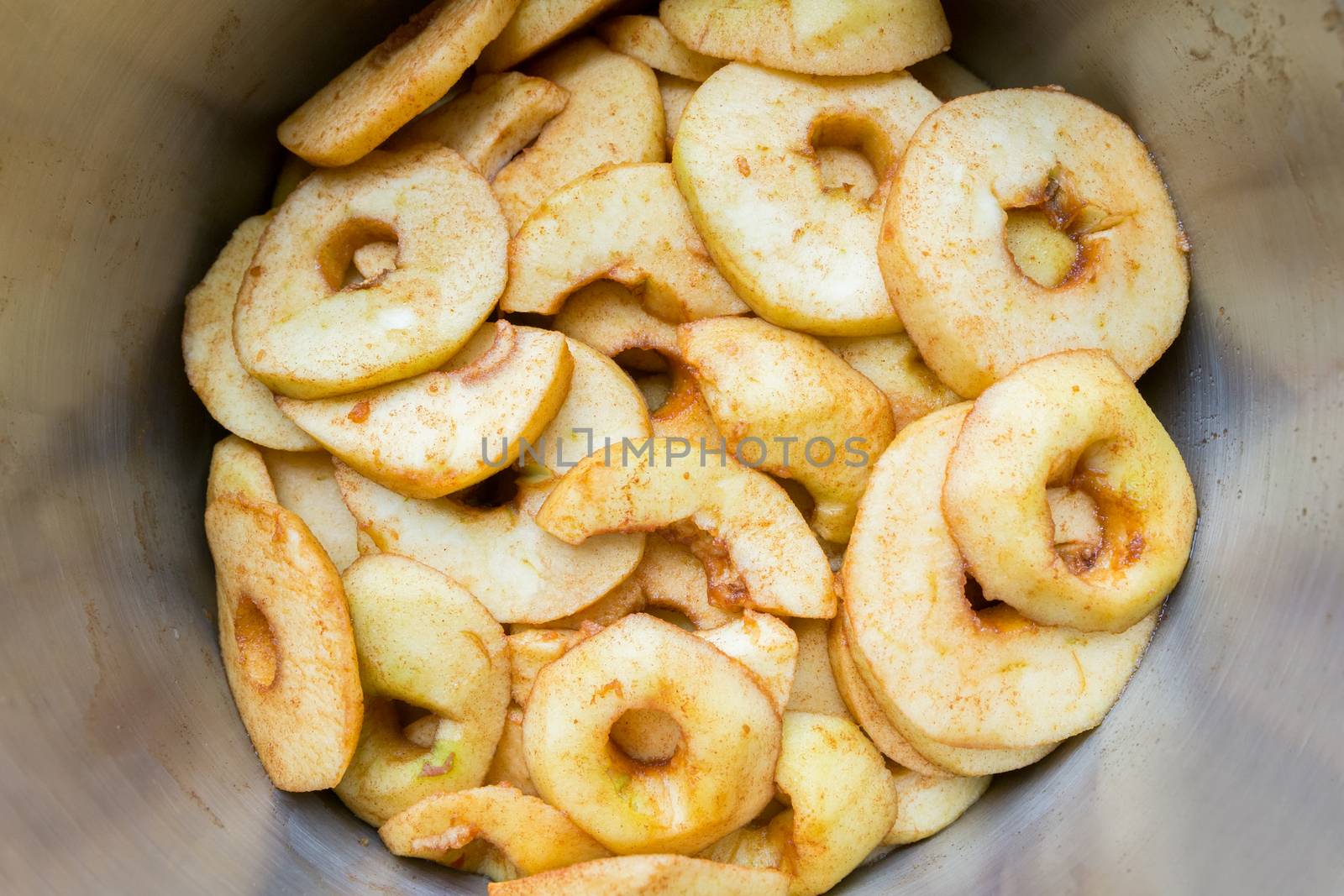 Many apple slices in metal pan by BenSchonewille
