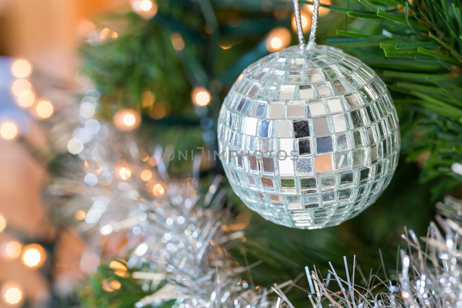 Christmas ball or bauble with little mirrors as decoration hanging in tree
