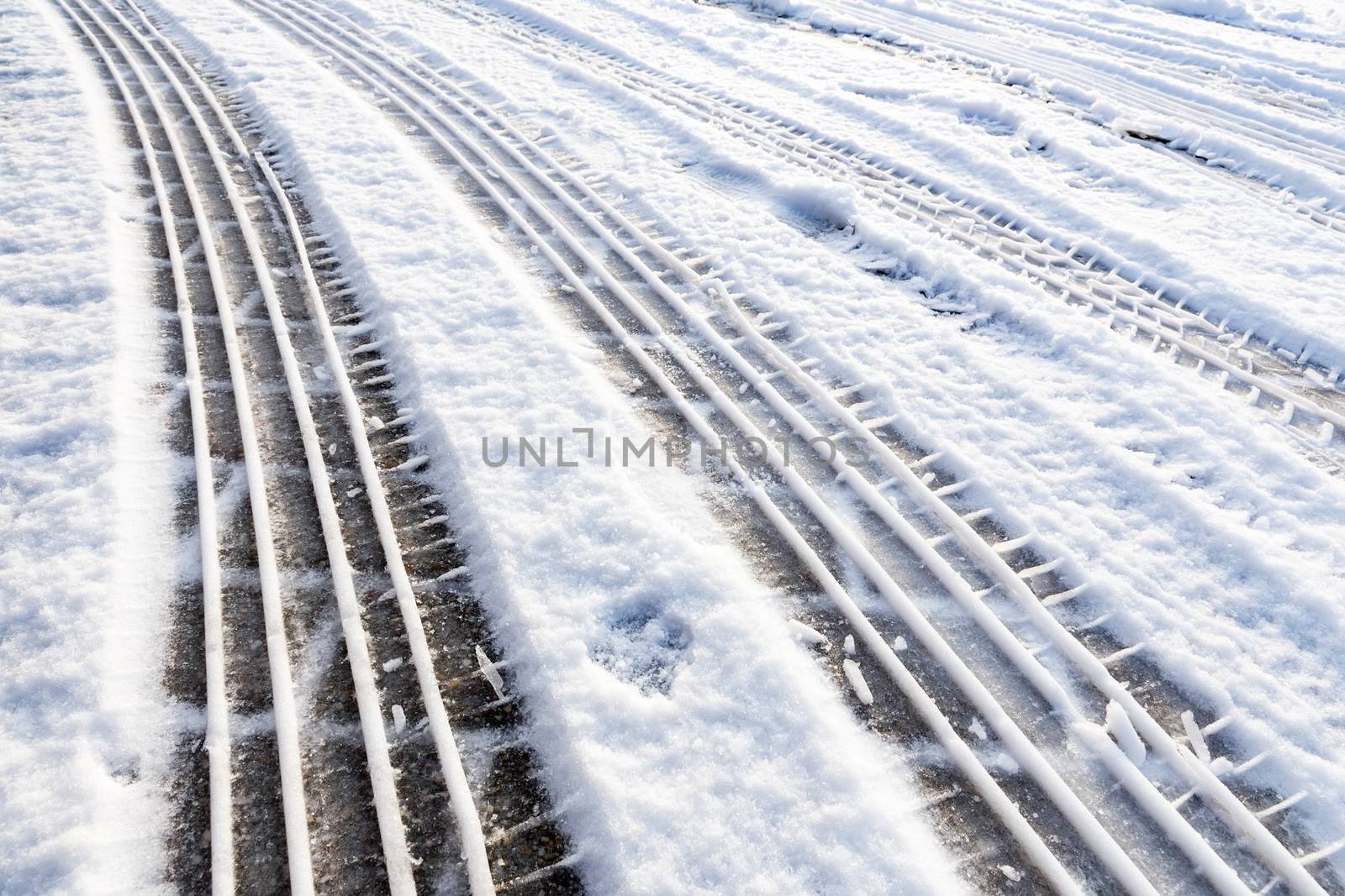 Car tire tracks in snow symbol of transport during winter season