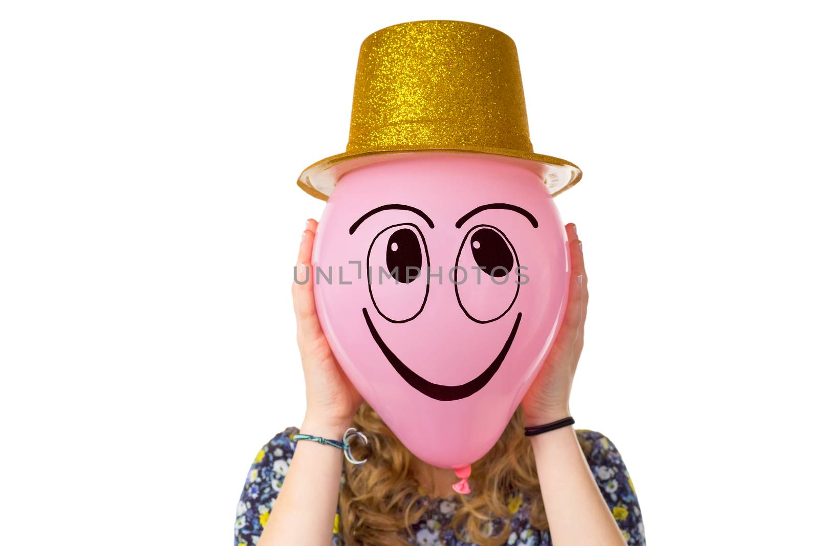 Girl holding balloon with expression of smiling face and gold hat isolated on white background