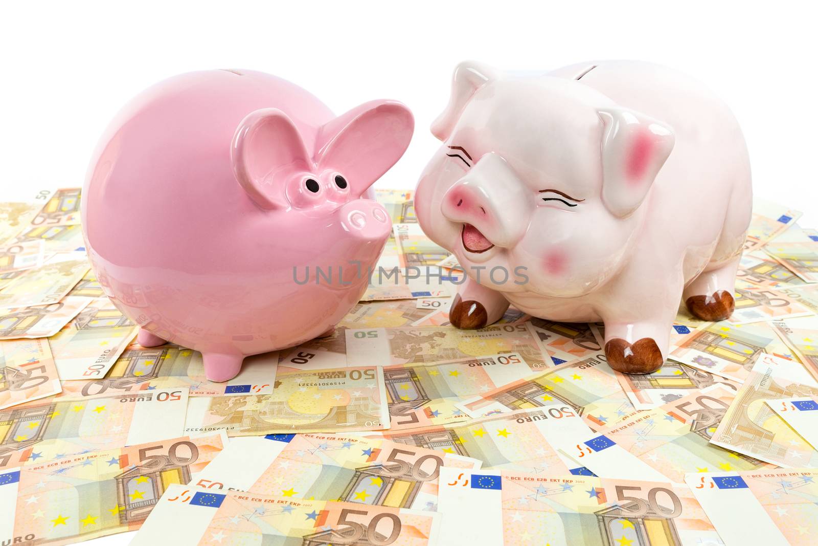 Two pink piggy banks on spread euro notes isolated on white background