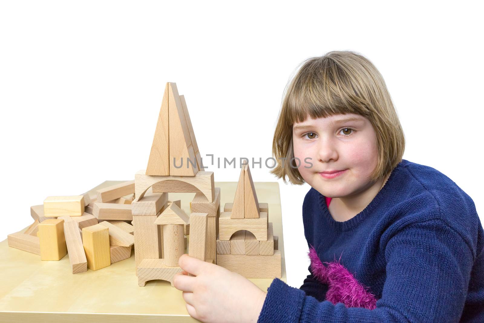 Young girl building construction with wooden blocks