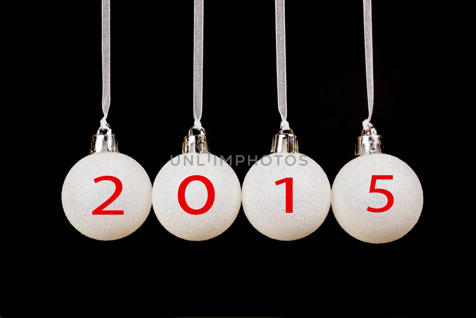Four white christmas balls with old year 2015 isolated on black background