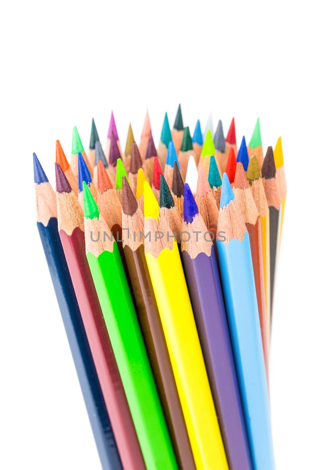 Various colered crayons standing upright isolated on white background