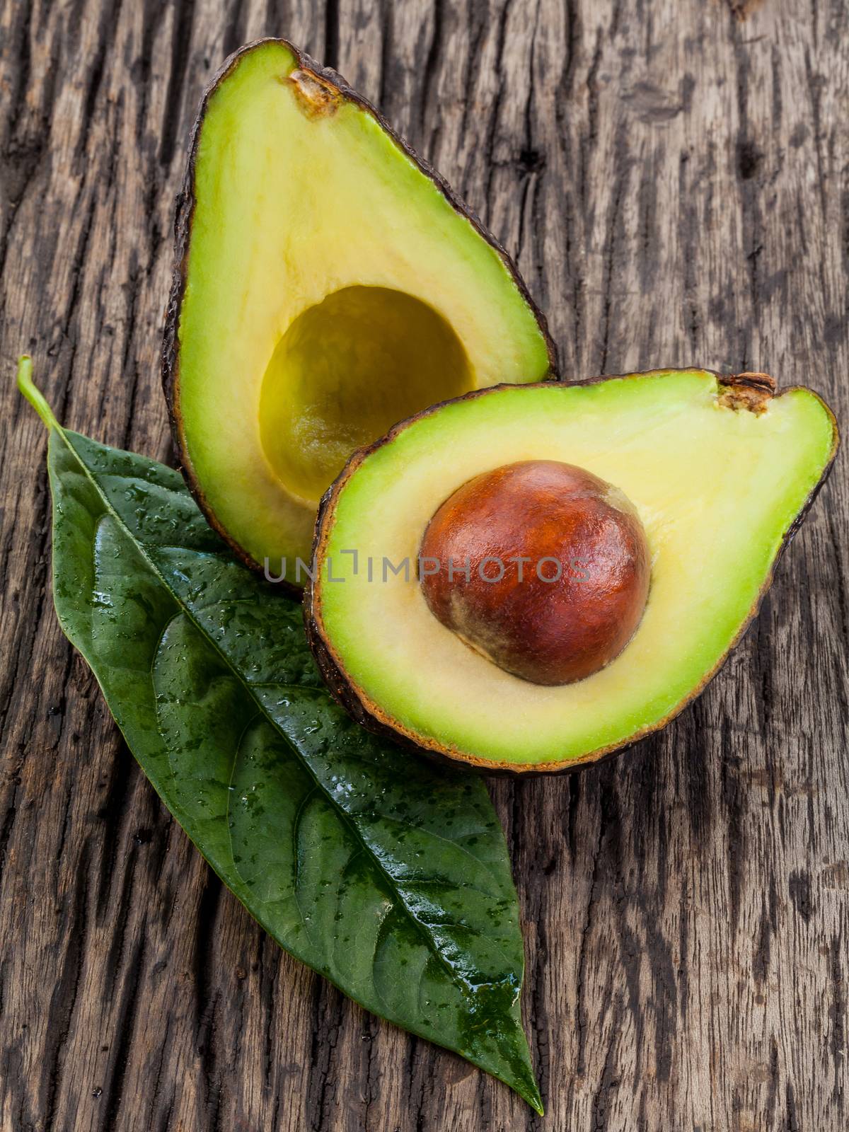 Halved avocado with core. - in macro shot.