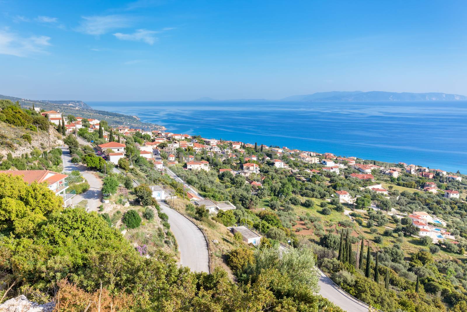 Greek village showing houses at coast near blue sea in Kefalonia Greece