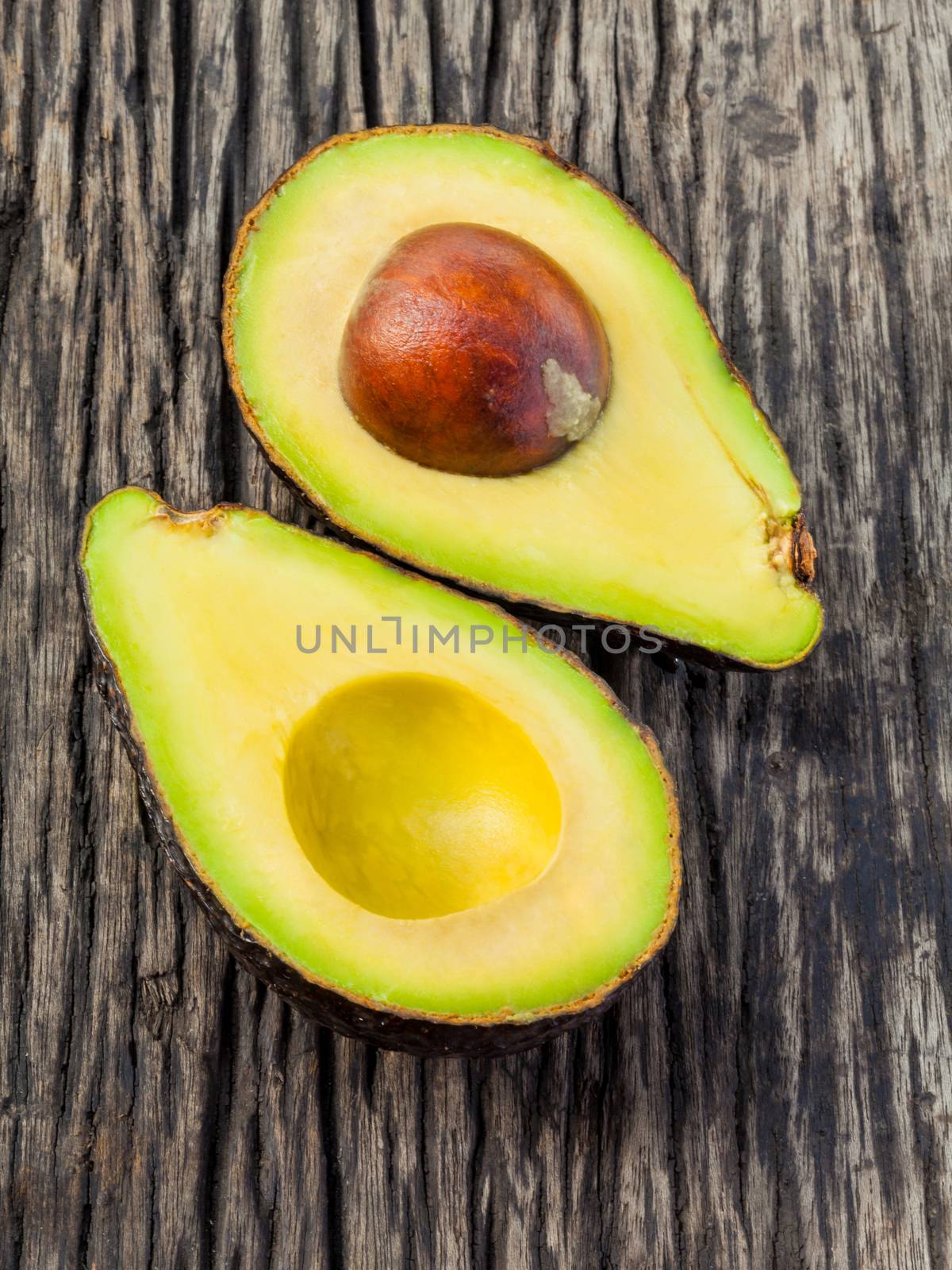 Halved avocado with core isolated on white - in macro shot.