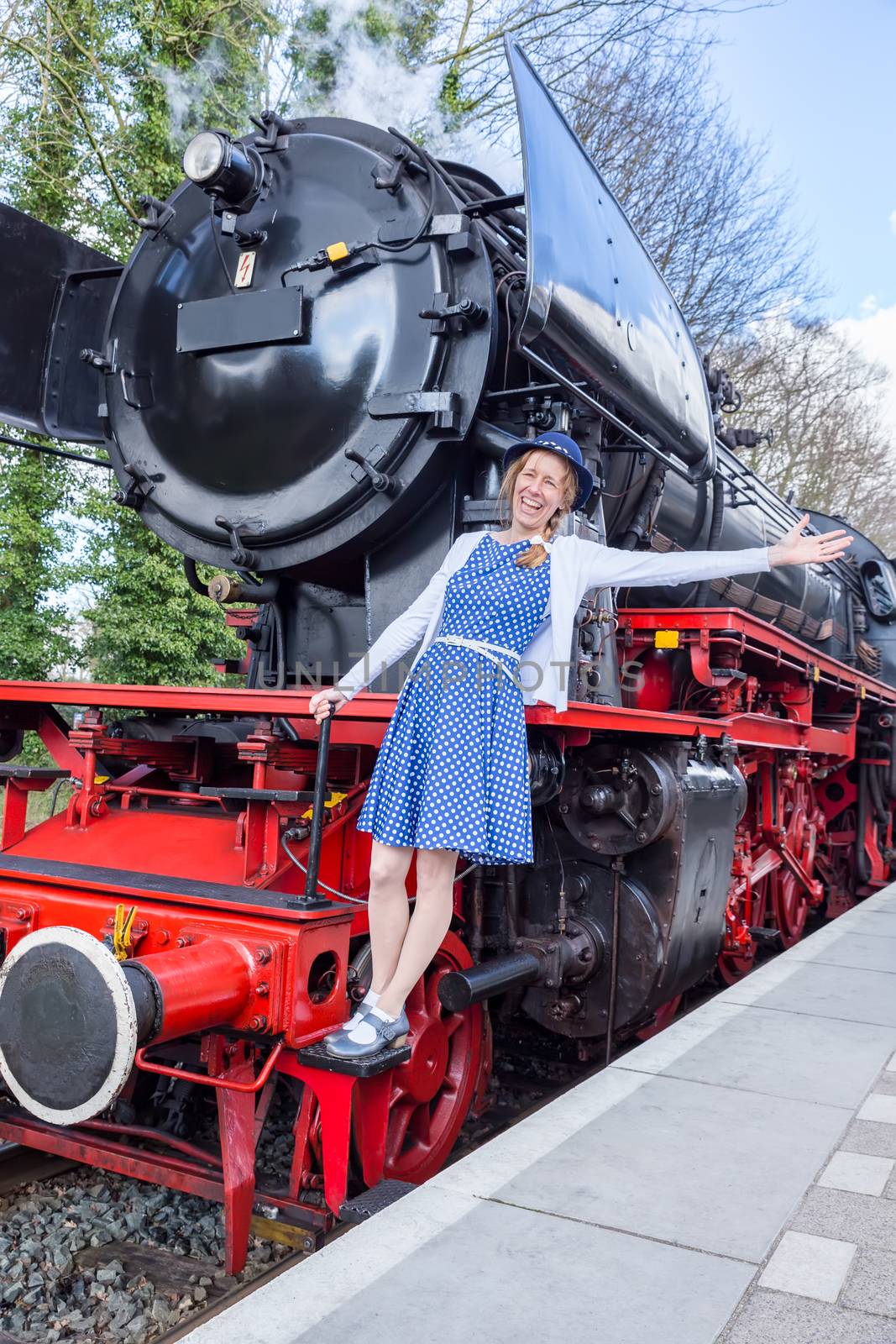 European middle aged woman expressing happiness for freedom and peace on steam train